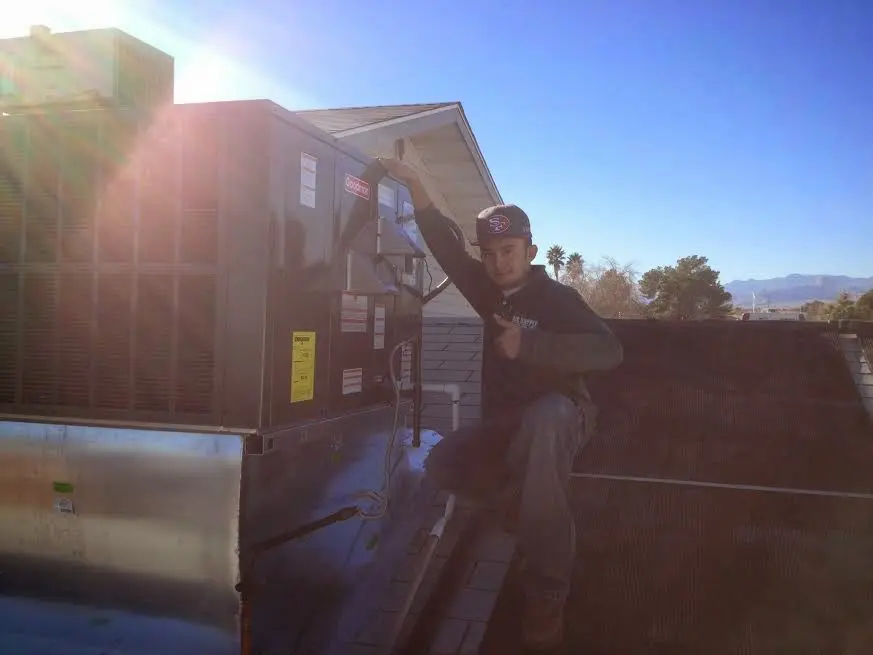 HVAC technician performing HVAC Inspection on a rooftop unit in Lake City